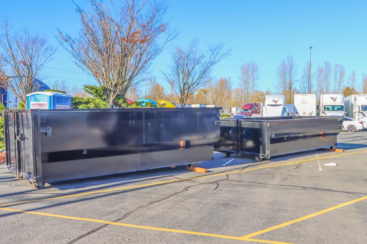 Professional dumpster rental service with roll-off container on residential driveway in Columbus